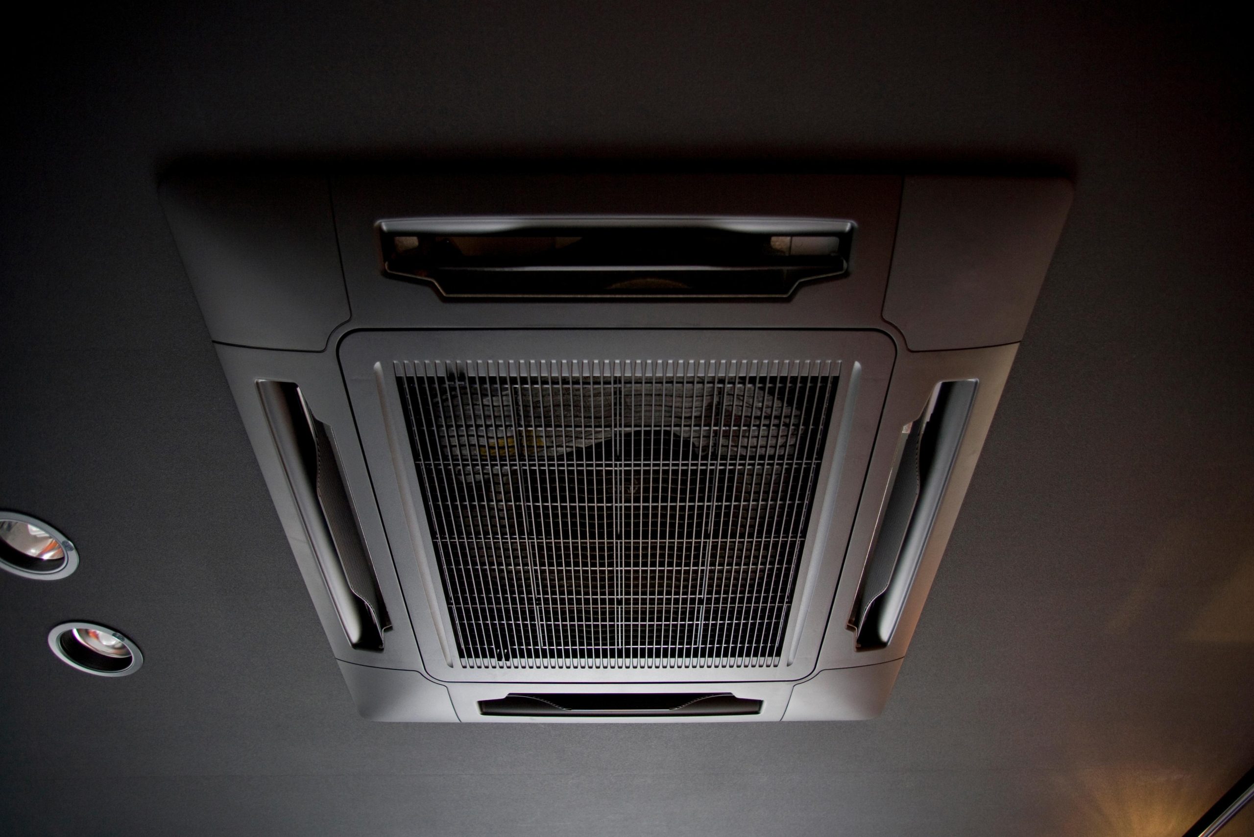 Technician inspecting Dubai AC ductwork with professional tools, showing a side-by-side view of dirty and cleaned coils for clear comparison.