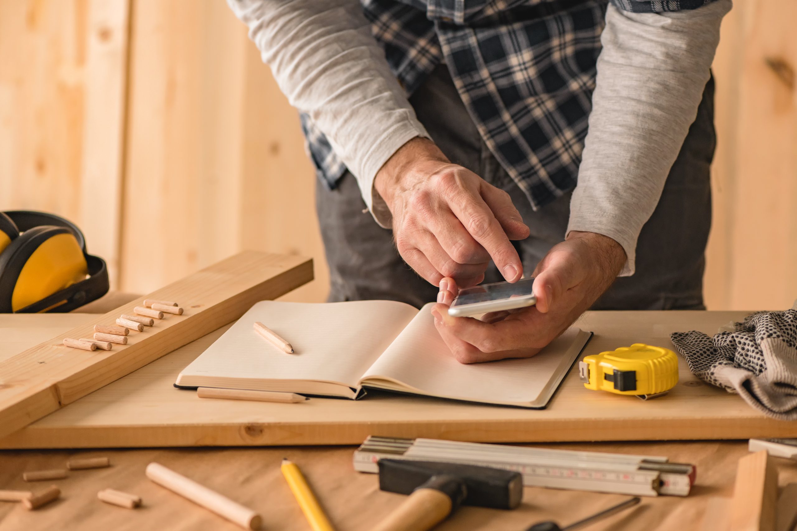 Dubai homeowner booking handyman services on a smartphone app with clear service options for TV mounting, furniture assembly, and small repairs.