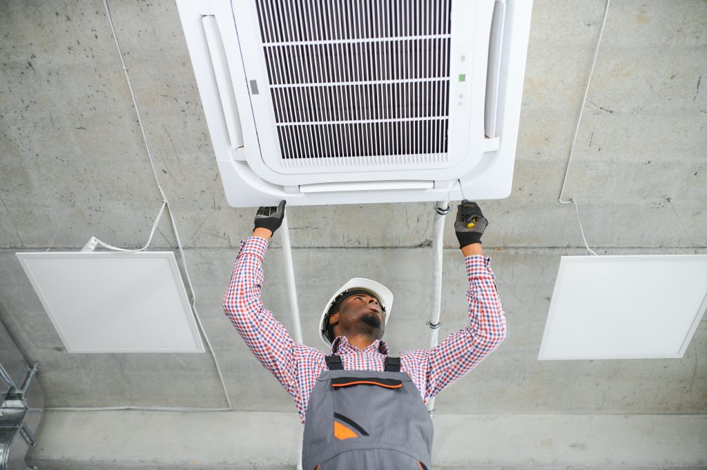 Gloved technician reinstalling a sparkling clean AC vent in Dubai, airflow graphics symbolizing fresh, sanitized air after duct cleaning.