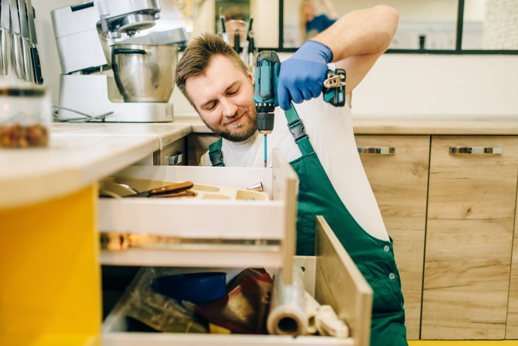 Friendly handyman in Dubai showing professional service quality during home repairs, symbolizing trusted, insured, and reliable handyman services.