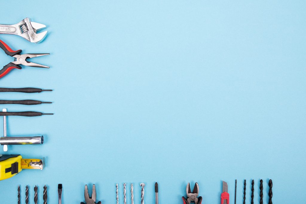 Neatly arranged AC coil cleaning tools including CoilJet sprayer, protective gloves, disinfectant bottles, and brushes used in Dubai AC services.