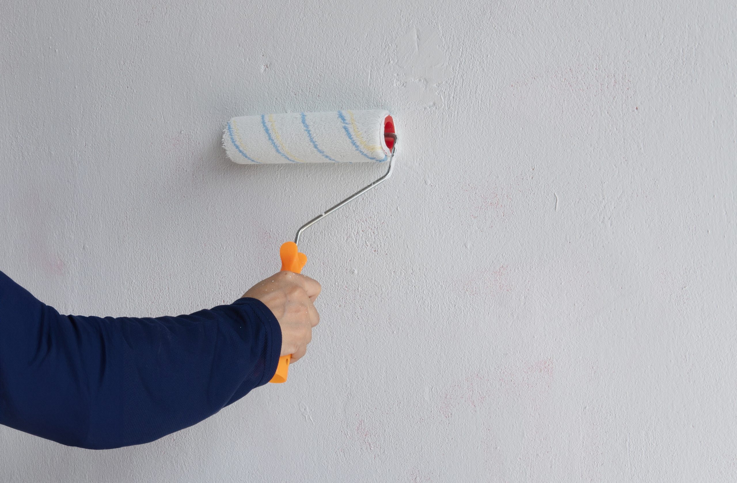 professional painters Ajman painting villa exterior wall with roller