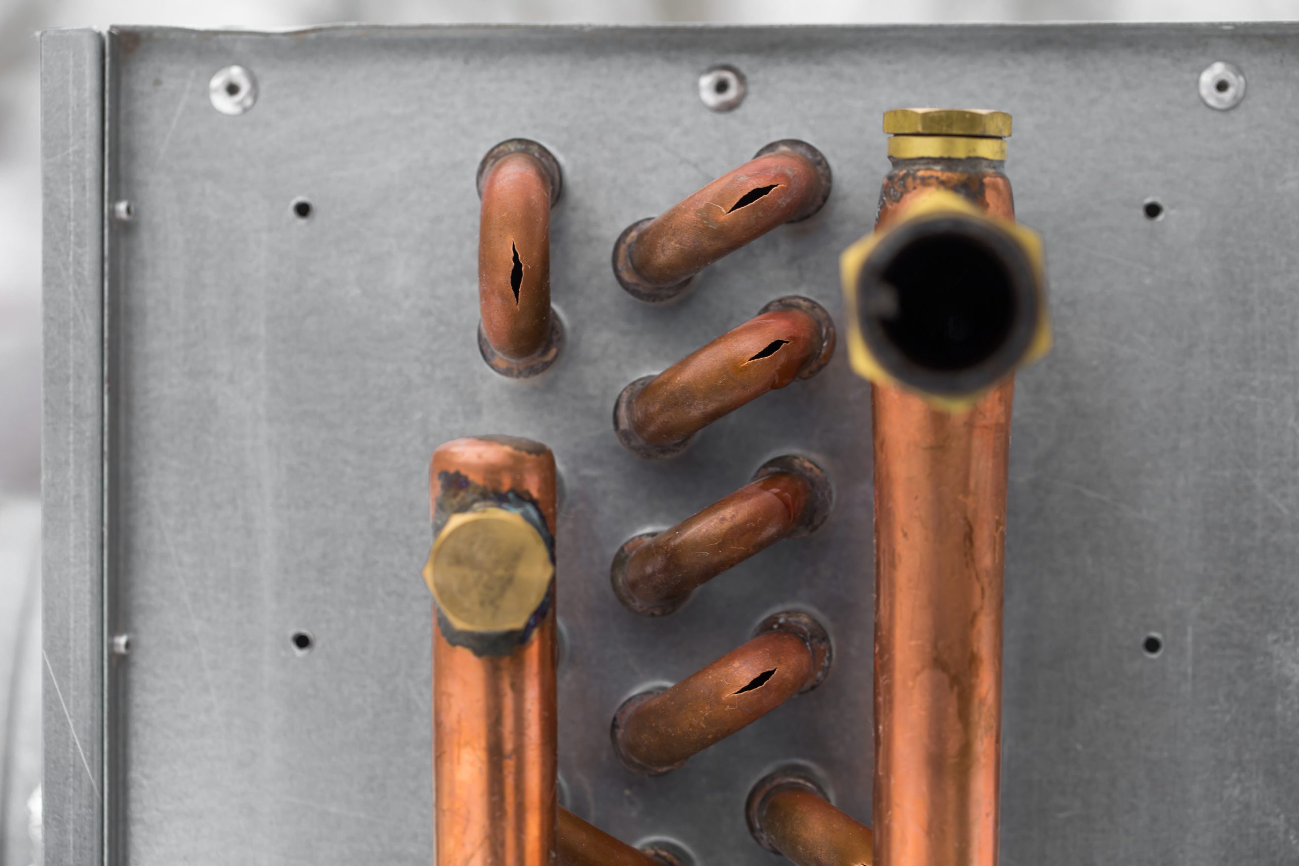 AC maintenance Sharjah technician deep cleaning condenser coil for better cooling efficiency.