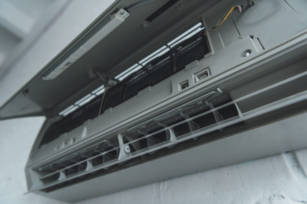 Licensed AC servicing Abu Dhabi showing clean AC coil after professional maintenance.