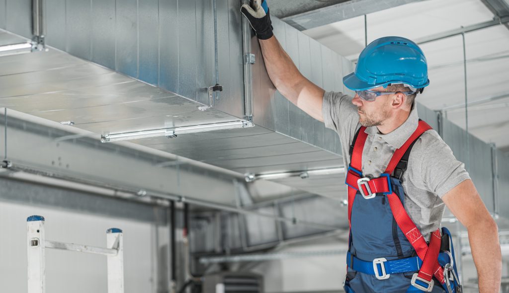AC duct sanitization Sharjah technician ready for same-day duct cleaning service.