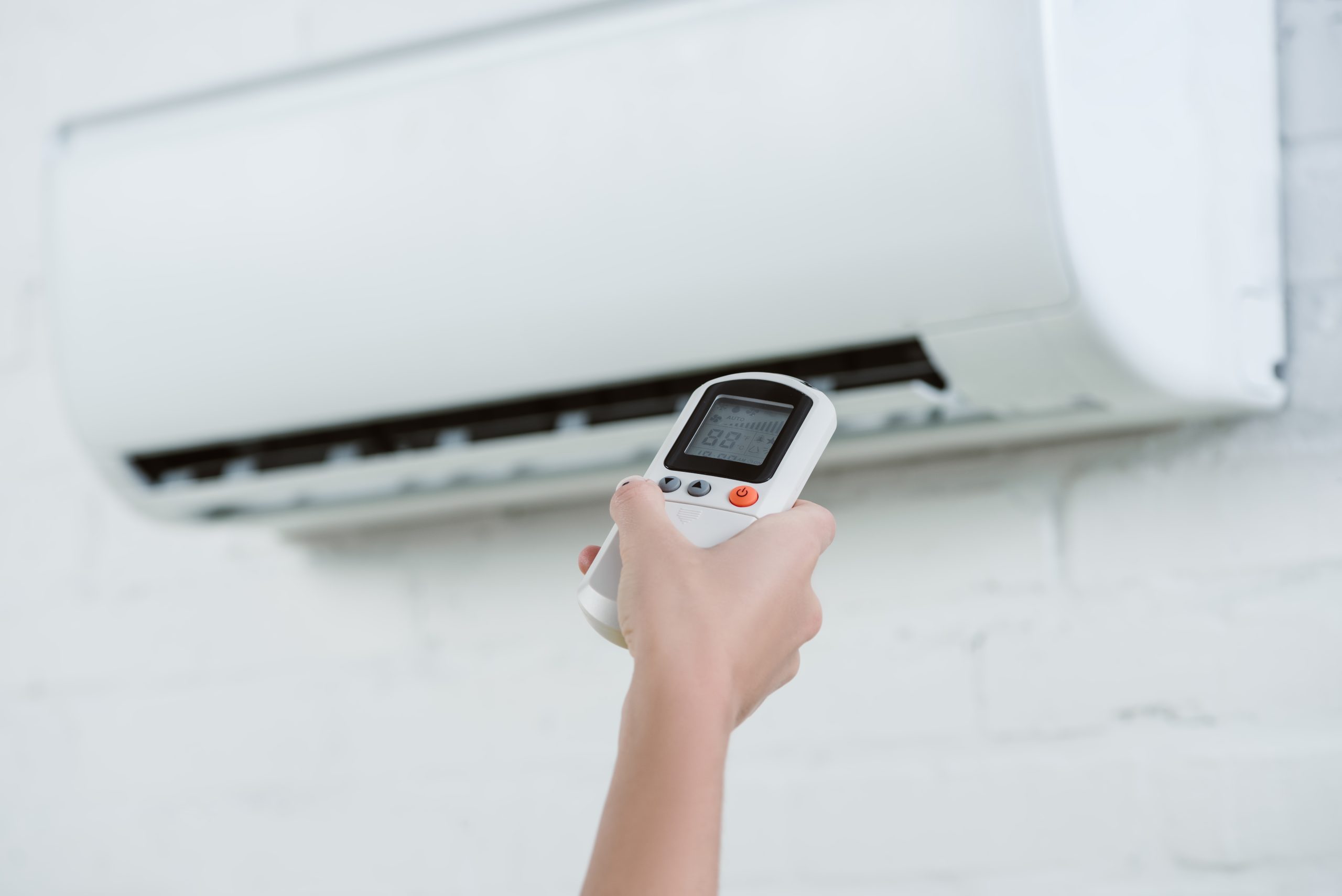 HVAC expert in Dubai inspecting AC coils and ductwork with professional diagnostic tools during detailed AC servicing.
