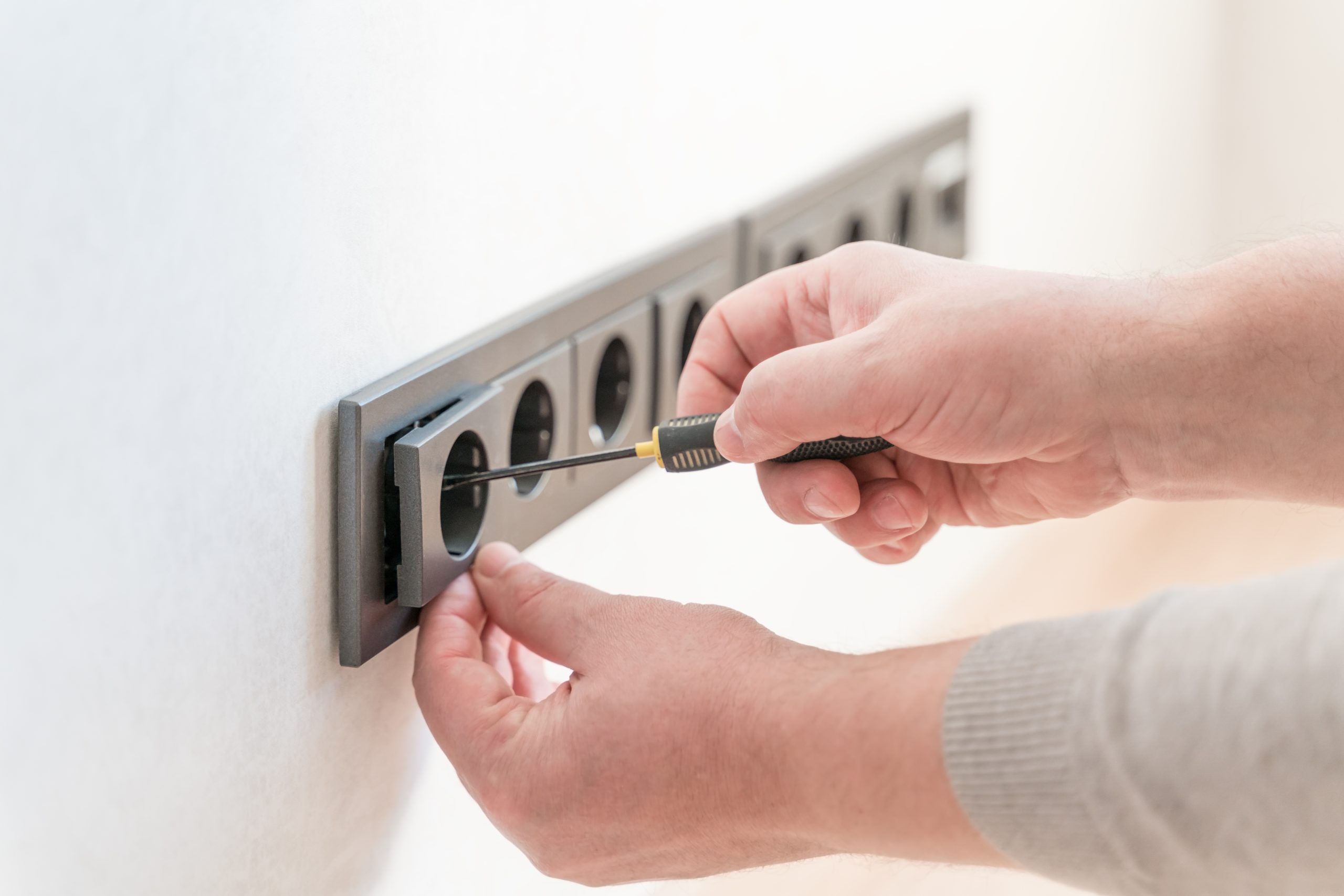 Electrician conducting wiring inspection during electrical maintenance in Sharjah.