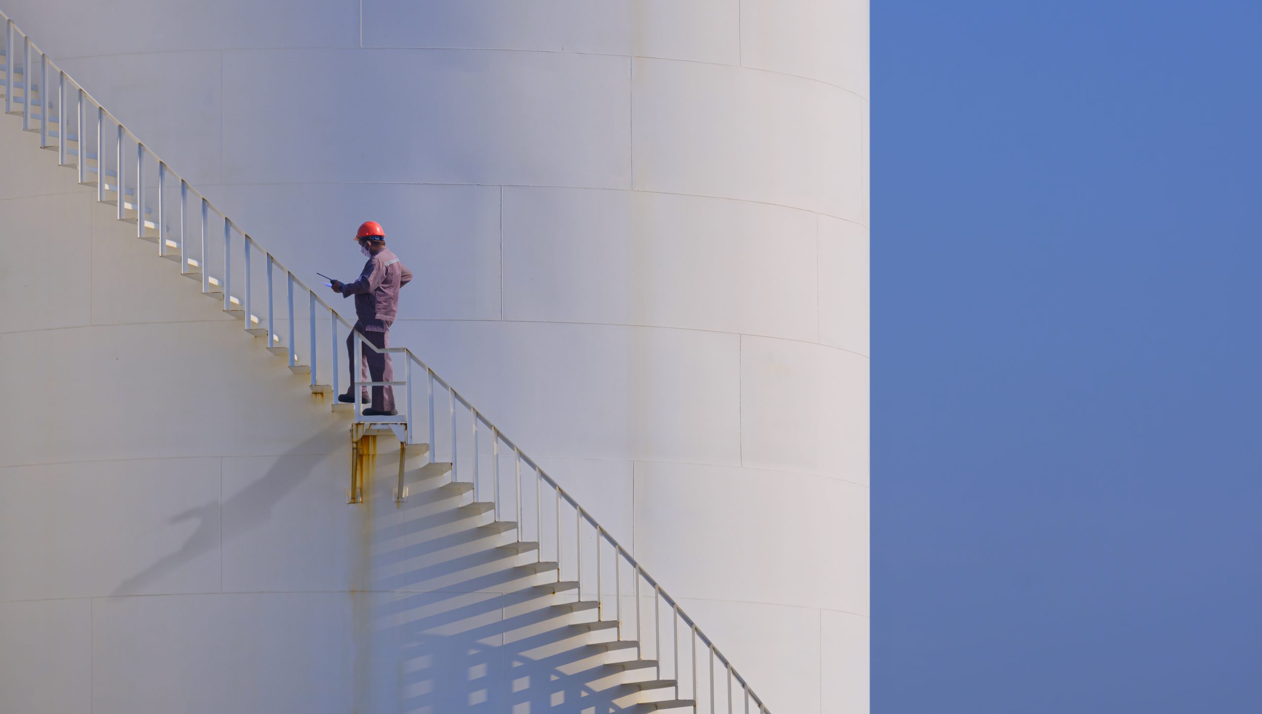 water tank cleaning Sharjah service technician spraying disinfectant inside residential tank