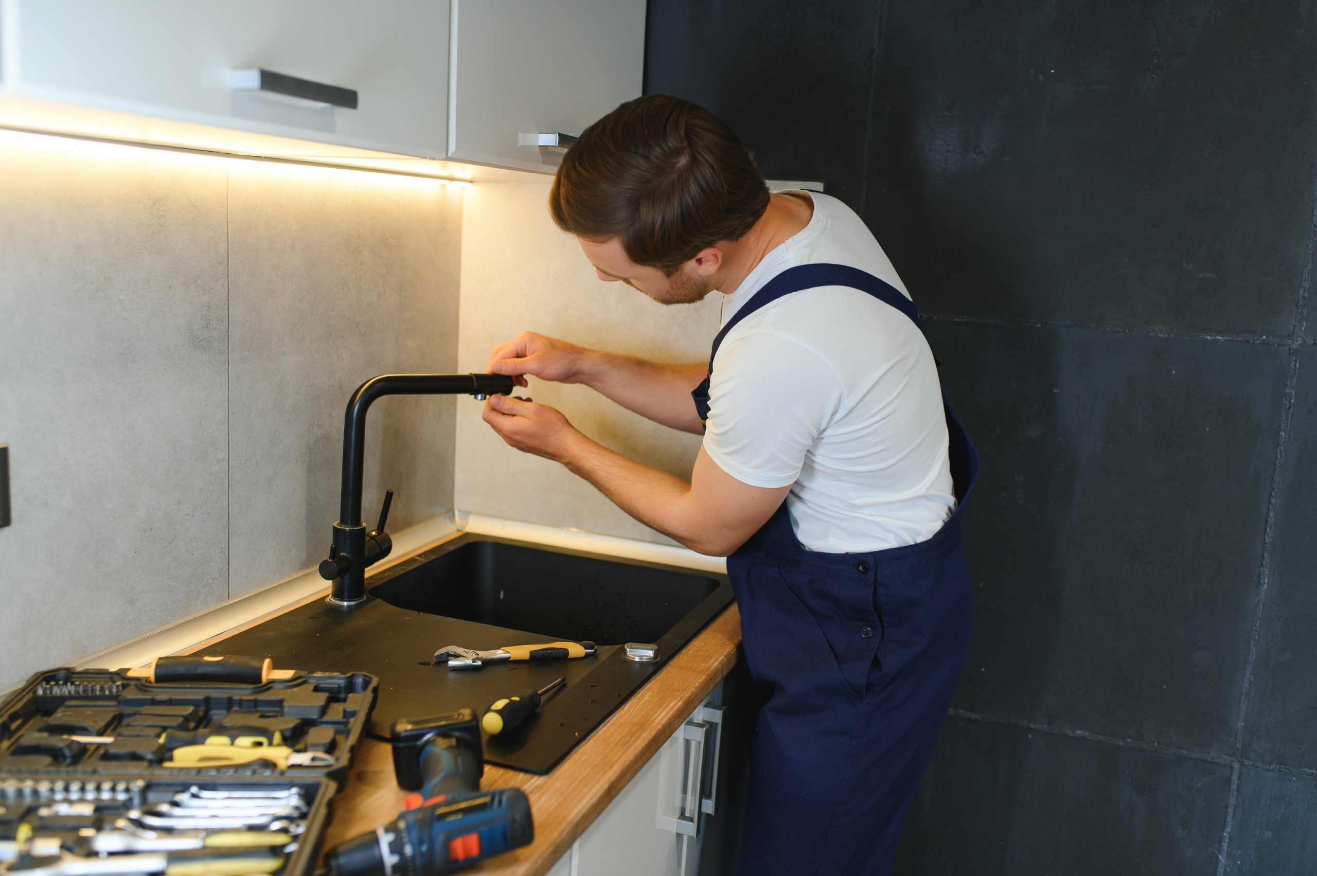 Local plumbing services Ajman team preparing for installation work.