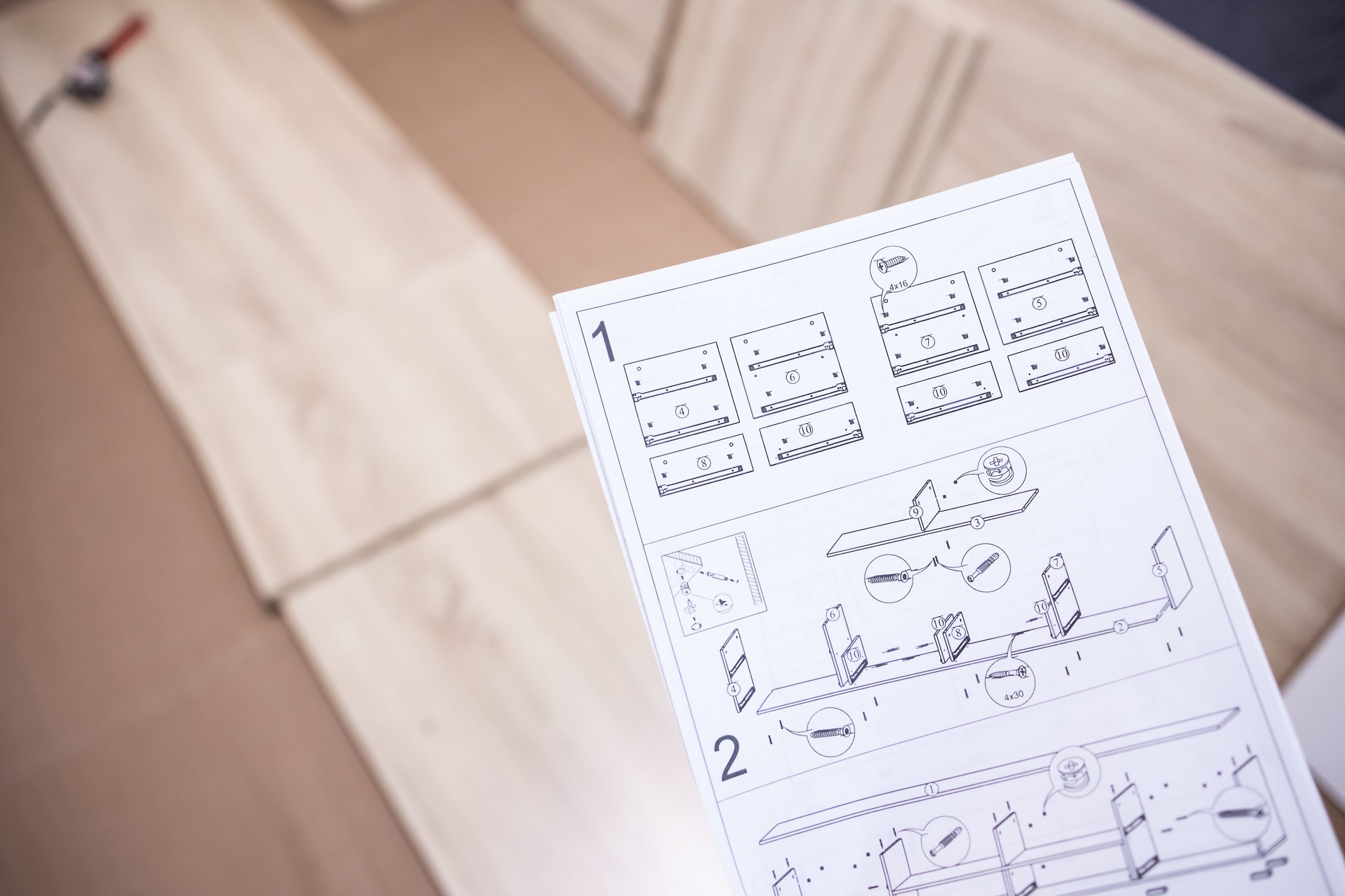 Professional carpenter in Dubai assembling a flat-pack IKEA table with precision tools and neatly cleared packaging.