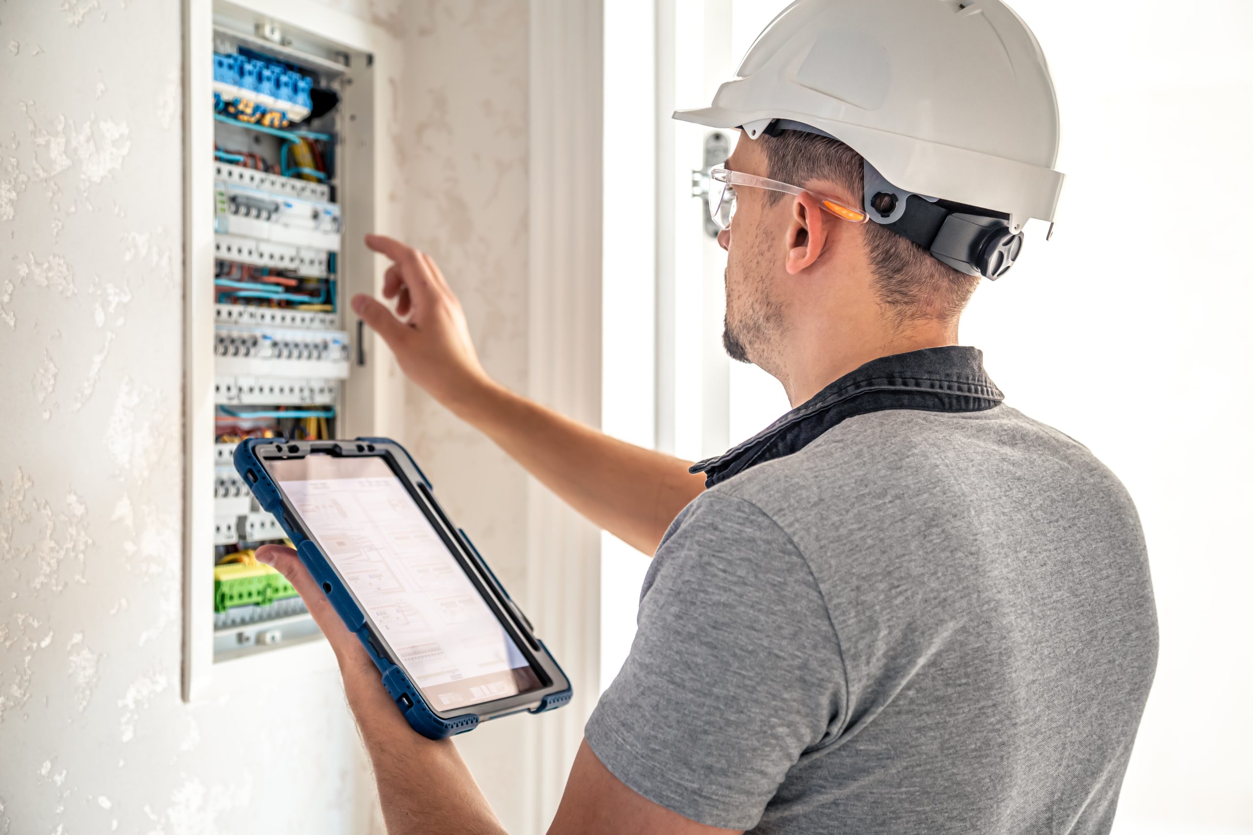 Technician inspecting home systems during handyman service in Sharjah.