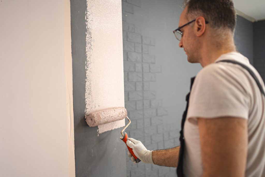 painter Sharjah applying smooth finish to modern interior wall