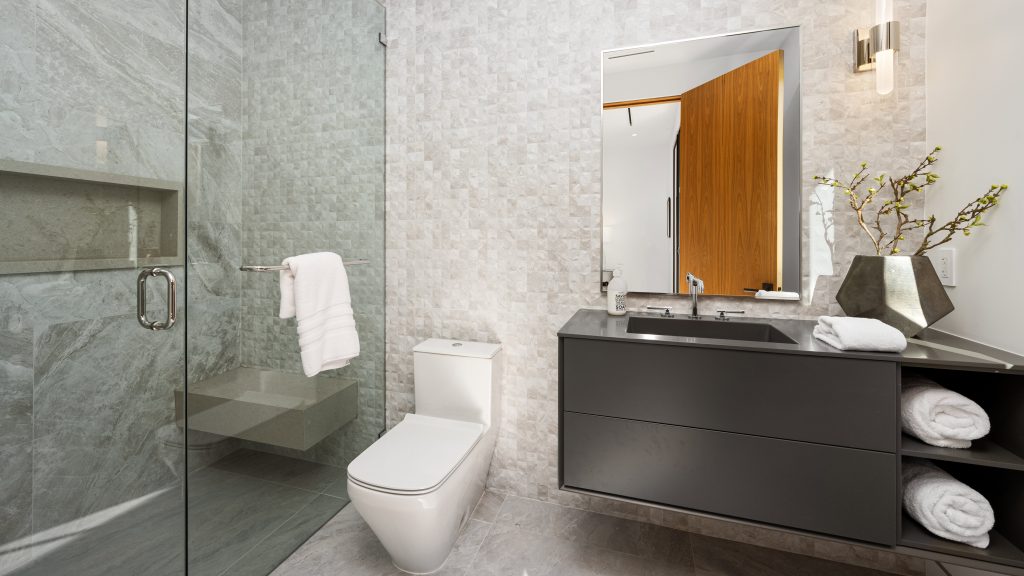 Bathroom sanitary installation Dubai - modern toilet, sink, and shower setup.