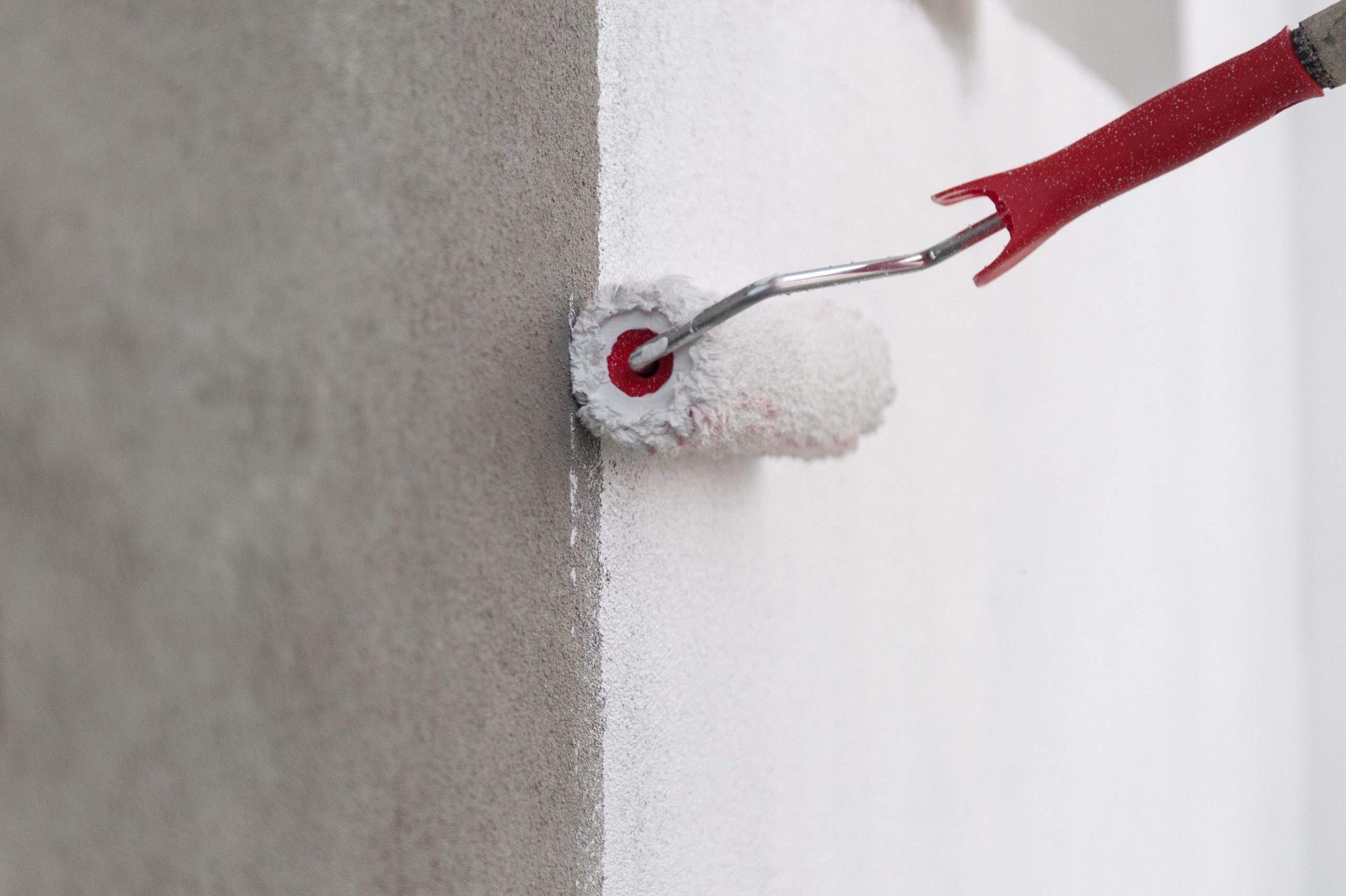 professional painters Sharjah applying paint to villa exterior wall with roller