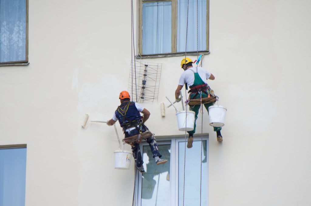 commercial painting UAE team painting multi-storey building on scaffolding