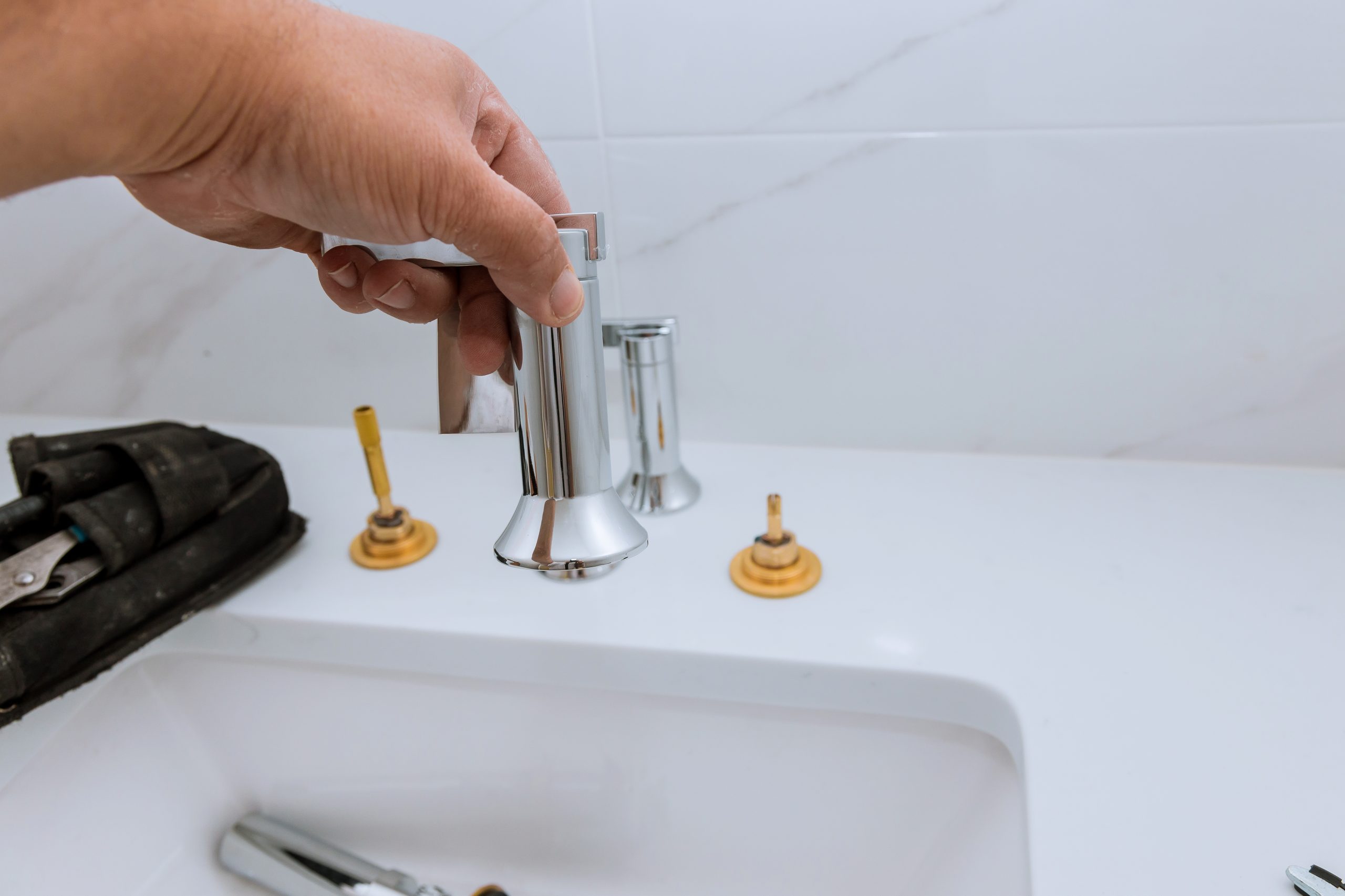 Emergency plumber Ajman using modern tools for leak detection in bathroom.