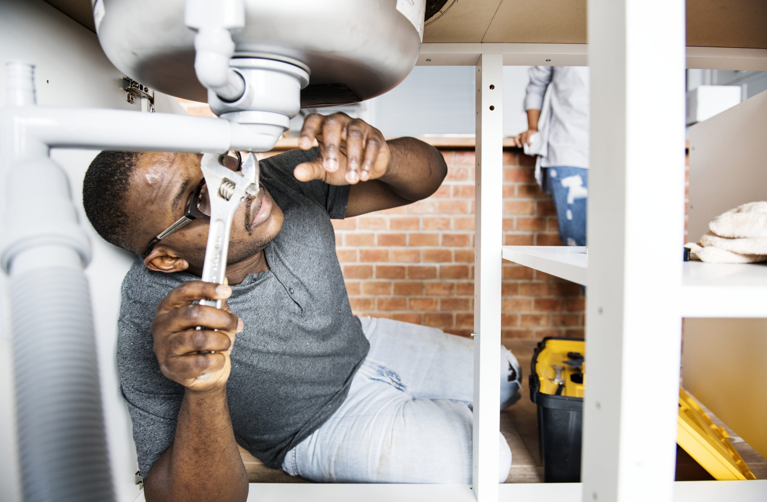 Plumber conducting home repair in UAE.