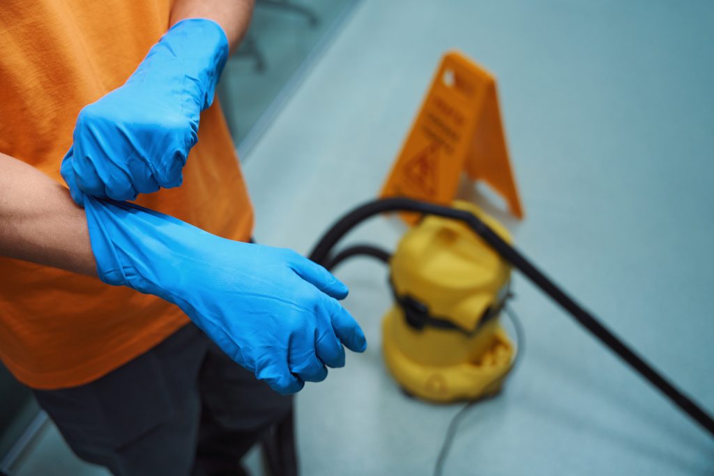 Trained technician in Abu Dhabi with cleaning equipment for water tank disinfection.