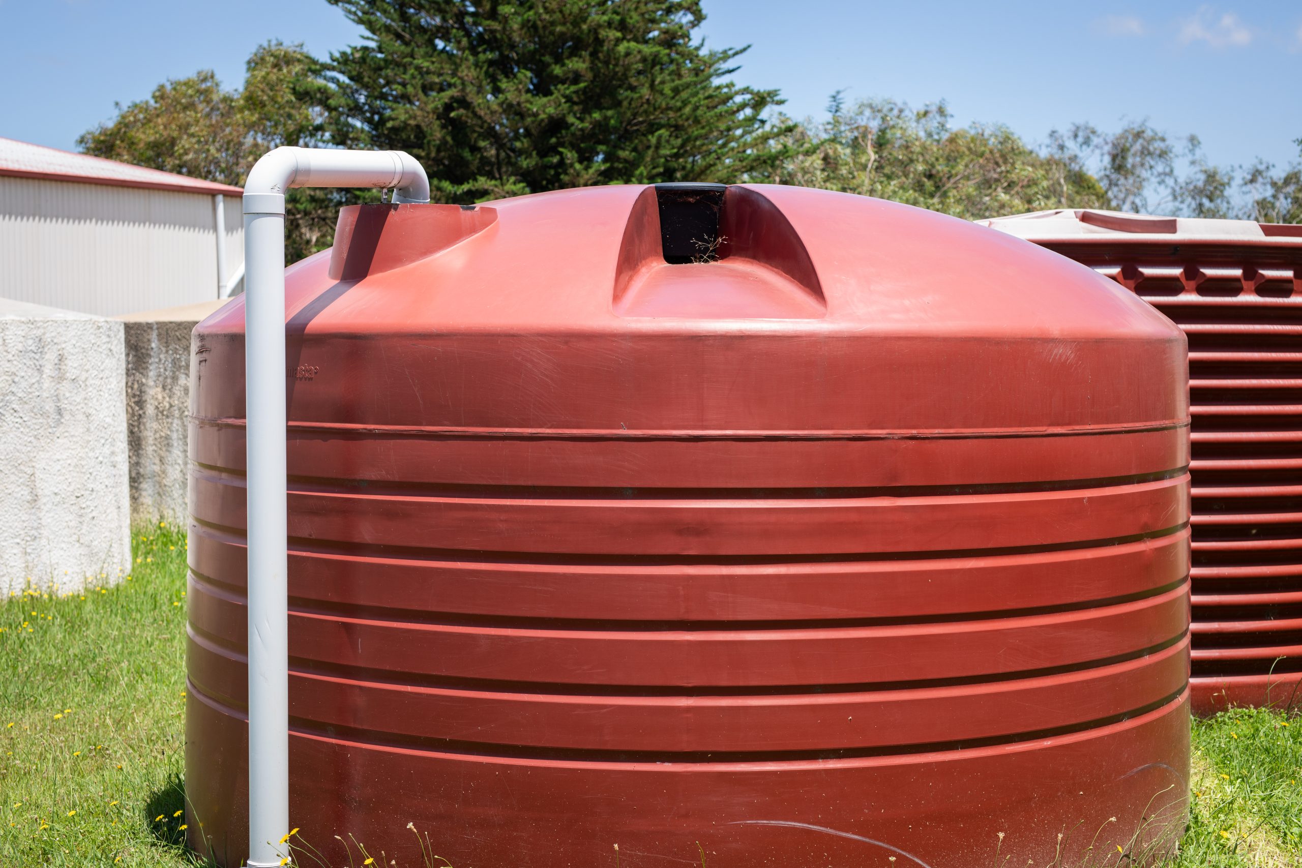 tank cleaning Sharjah inspection inside residential water tank with flashlight