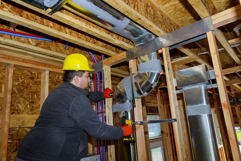AC duct sanitization UAE technician holding sanitization equipment inside villa.