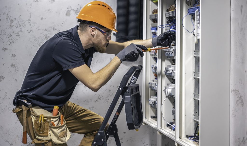 Electrician performing lighting installation in Abu Dhabi.