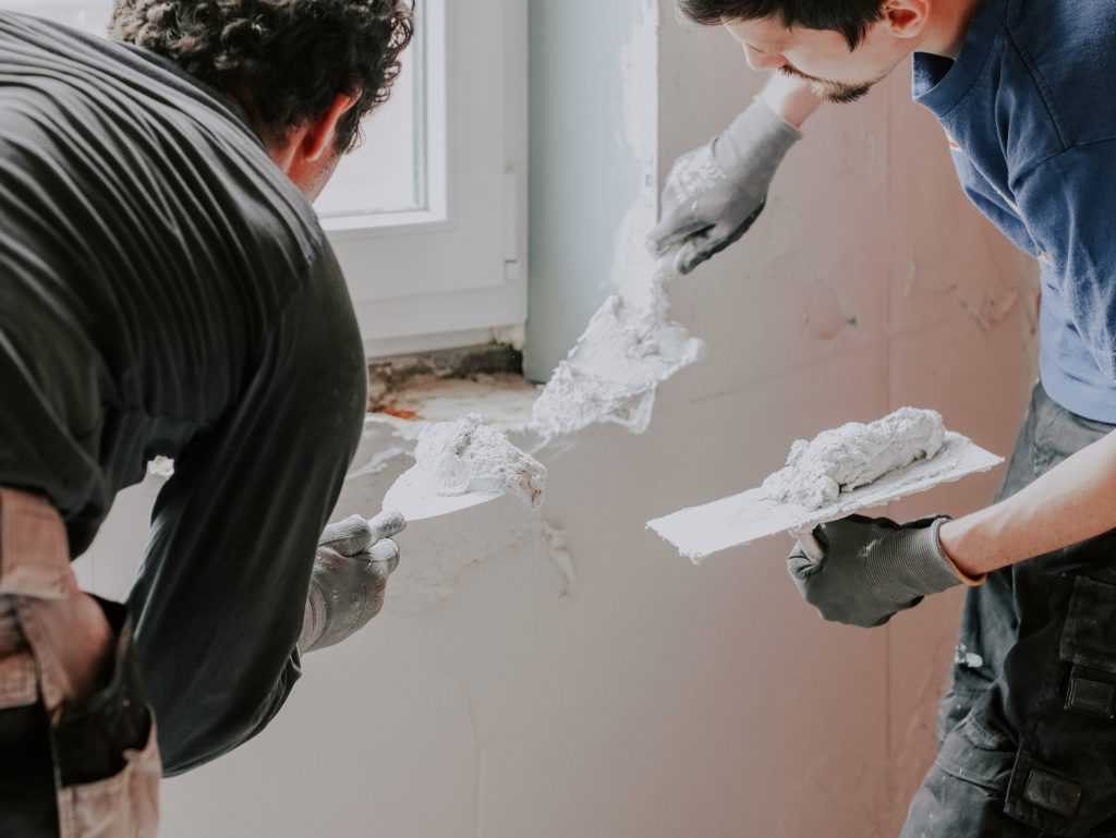 Plasterers working on interior and exterior walls of a Dubai property.