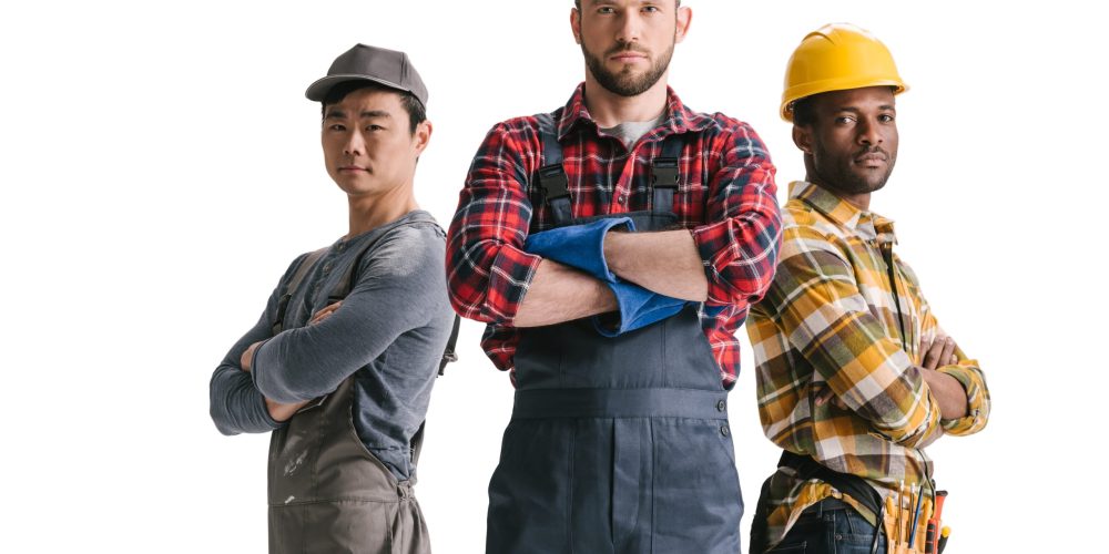 Group of licensed handyman UAE professionals standing in front of branded service van with UAE landmarks in the background.