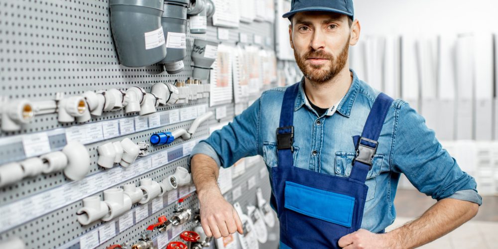 Certified plumber Sharjah providing plumbing services and repairing kitchen sink with professional tools.
