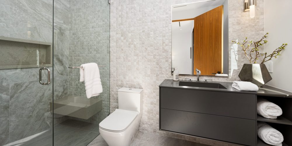 Bathroom sanitary installation Dubai - modern toilet, sink, and shower setup.