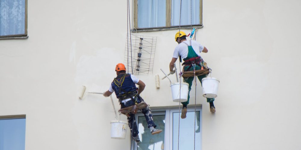 commercial painting UAE team painting multi-storey building on scaffolding