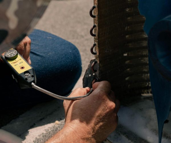 Professional AC Coil Cleaning UAE Technician cleaning AC coils for better airflow
